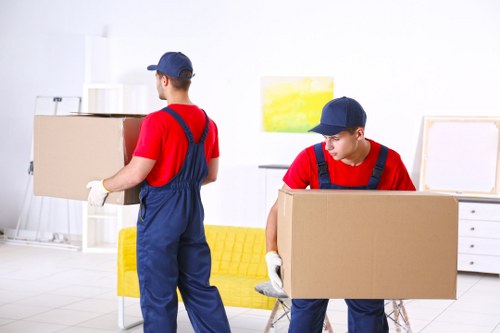 Removal team loading boxes and furniture for a house move in Bromley