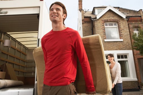 Professional movers handling furniture in a Bromley street