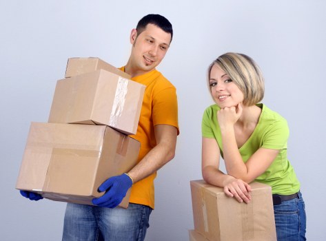 Professional movers handling office furniture and boxes
