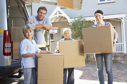 Local removal team carrying boxes from a Bromley property