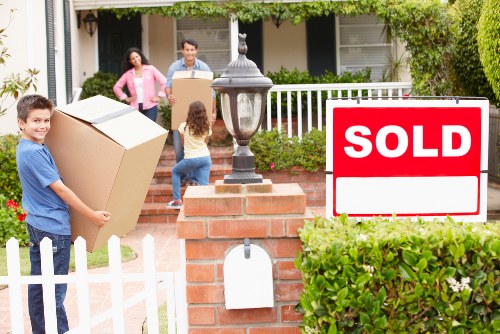 Professional movers handling furniture and boxes during a Bromley house move